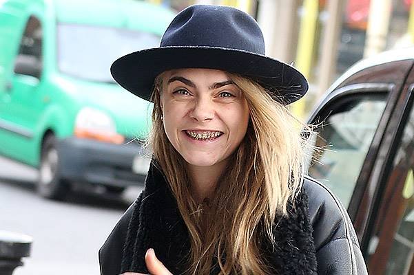 EXCLUSIVE: Gold toothed Cara Delevingne sports a 'grill' as she heads out with pal Michelle Rodriguez in Notting Hill  on February 1, 2014