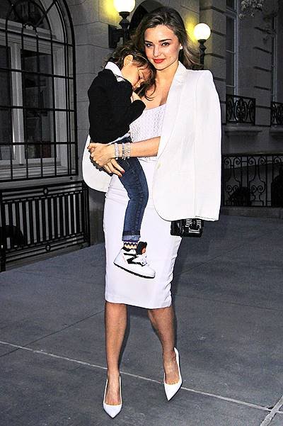Miranda Kerr carries her sleepy son Flynn as she heads to dinner in NYC