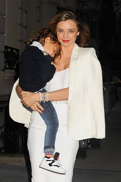 Miranda Kerr dresses in all white while carrying baby Flynn two days before her birthday