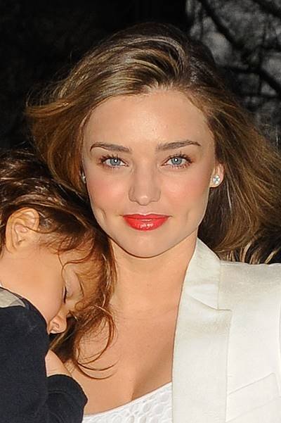 Miranda Kerr dresses in all white while carrying baby Flynn two days before her birthday