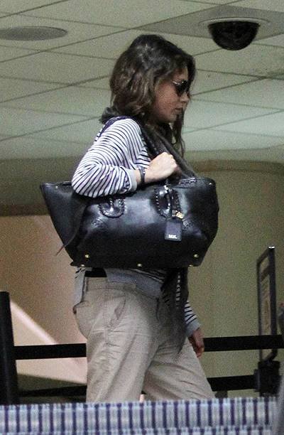 Ashton Kutcher and rumoured to be pregnant fiance Mila Kunis touch down at LAX airport