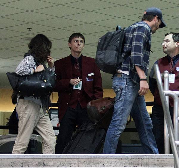 Ashton Kutcher and rumoured to be pregnant fiance Mila Kunis touch down at LAX airport