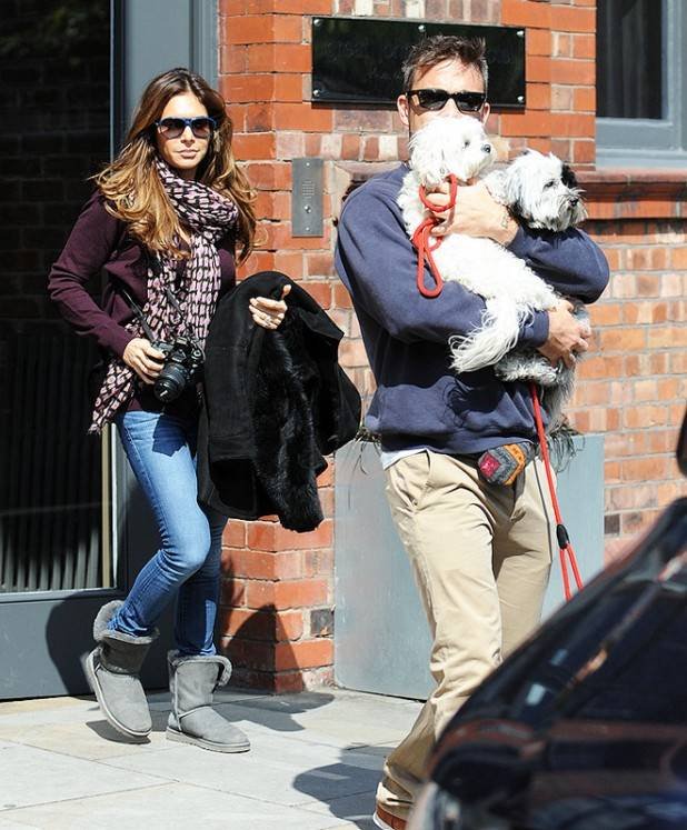 Robbie Williams and wife leave Great John Street hotel in Manchester todayhe sheilded his face with his two dogs.