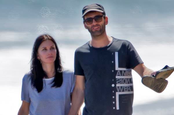 EXCLUSIVE: Courteney Cox shares a tender kiss with her boyfriend while walking on the beach in Malibu