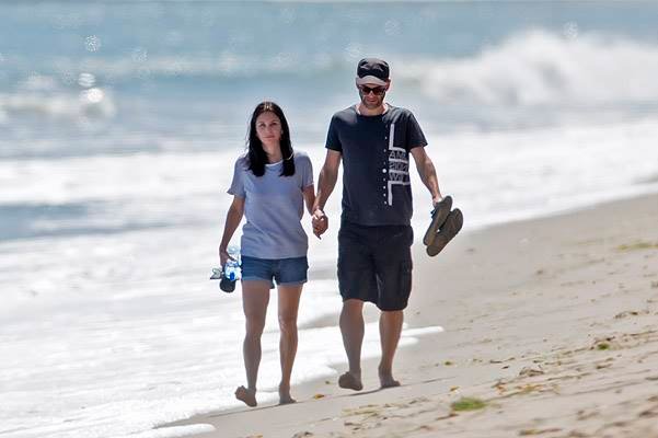 EXCLUSIVE: Courteney Cox shares a tender kiss with her boyfriend while walking on the beach in Malibu