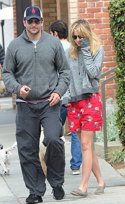 EXCLUSIVE: Actor Bradley Cooper and his girlfriend Suki Waterhouse stop and chat with some friends as they walk hand in hand along Abbot Kinney Boulevard in Venice, CA after having breakfast at 3 Square Cafe