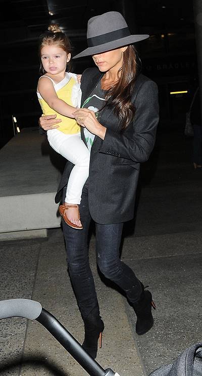 Victoria Beckham arrives at Los Angeles International (LAX) airport carrying daughter Harper Featuring: Victoria Beckham,Harper Beckham Where: Los Angeles, California, United States When: 18 Jul 2014 Credit: WENN.com