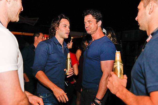 *EXCLUSIVE* Taylor Kitsch and Gerard Butler share a cold one in Rio