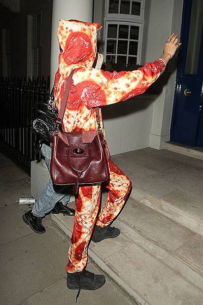 Cara Delevingne arriving home from Ibiza wearing a Pepperoni Pizza Onesie
