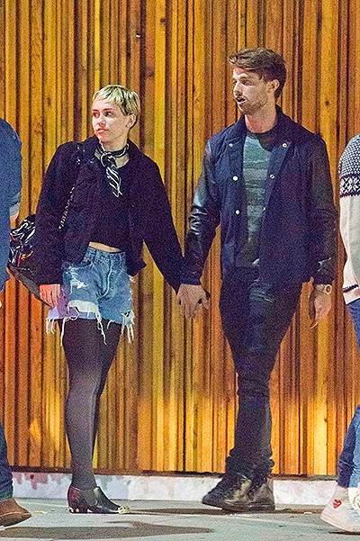 EXCLUSIVE: **PREMIUM RATES APPLY** Miley Cyrus meets Patrick Schwarzenegger's friends as they are spotted outside Mr Nice Guy in West Hollywood