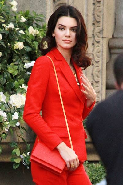 Kendall Jenner seen in a red suit for a photo shoot