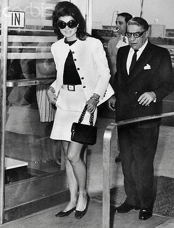 05 Jun 1969, Queens, New York, New York, USA --- Wearing mod sunglasses and a miniskirt, Jacqueline Kennedy Onassis accompanies her husband, Aristotle, to a plane at Kennedy Airport on today, before the Greek shipping magnate took off for Athens. Ari was flying his own Olympic Airways to Europe and Jackie came along to the airport to say goodbye. --- Image by © Bettmann/CORBIS